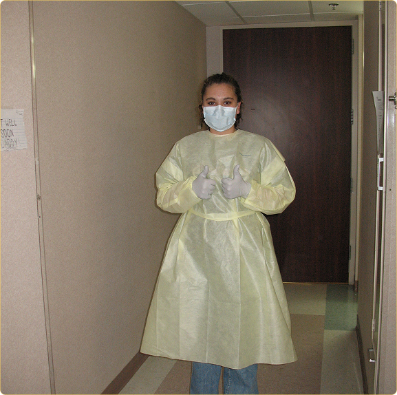 Brittany in hospital gown to visit her dad one in the hospital when his white blood count plummeted after chemo.